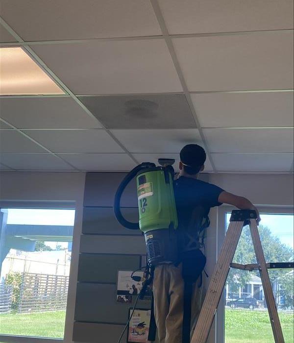 SERVPRO crew member cleaning mold from the ceiling
